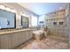 Bright bathroom featuring double vanity, soaking tub, and tiled walk-in shower at 2300 Lord Anson Dr, Waxhaw, NC 28173
