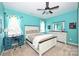 Cozy bedroom with turquoise walls, white furniture, a desk, a ceiling fan, and natural light at 2300 Lord Anson Dr, Waxhaw, NC 28173