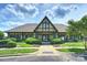 A view of the clubhouse with a well-maintained lawn and lush landscaping at 2300 Lord Anson Dr, Waxhaw, NC 28173