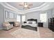 Spacious main bedroom featuring tray ceilings, a ceiling fan, and a decorative fireplace at 2300 Lord Anson Dr, Waxhaw, NC 28173