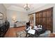 Functional home office featuring hardwood floors and a decorative sliding barn door at 2300 Lord Anson Dr, Waxhaw, NC 28173