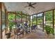 Relaxing screened-in porch with wicker furniture, a ceiling fan, and views of the lush backyard at 2300 Lord Anson Dr, Waxhaw, NC 28173