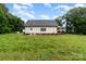 Spacious backyard with a lush green lawn and a view of the home's back exterior at 2451 Reepsville Rd, Lincolnton, NC 28092