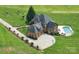 Expansive aerial view of a home with a private pool and a long driveway on a well-manicured lawn at 270 Sandhills Ct, Mooresville, NC 28115