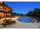 Stunning backyard with fenced in pool, lounge chairs, and covered porch at 270 Sandhills Ct, Mooresville, NC 28115