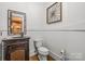 Powder room featuring a carved vanity, framed mirror, and decorative wall art at 270 Sandhills Ct, Mooresville, NC 28115