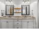 Bathroom featuring a double vanity with granite countertops, framed mirrors, and modern fixtures at 270 Sandhills Ct, Mooresville, NC 28115