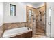 Bathroom featuring a tub and walk-in shower with ceramic tile at 270 Sandhills Ct, Mooresville, NC 28115