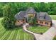 Aerial shot of home featuring lush landscaping, mature trees, and gray shingle roof at 270 Sandhills Ct, Mooresville, NC 28115