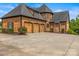 Home's exterior shows a three car garage, and manicured landscaping at 270 Sandhills Ct, Mooresville, NC 28115