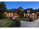 Inviting home at twilight showcasing warm exterior lighting and manicured landscaping at 270 Sandhills Ct, Mooresville, NC 28115