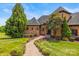 Charming home exterior featuring a stone walkway, manicured lawn, and mature trees at 270 Sandhills Ct, Mooresville, NC 28115