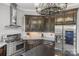 Gourmet kitchen boasts granite countertops, stainless steel appliances, and dark wood cabinetry at 270 Sandhills Ct, Mooresville, NC 28115