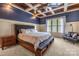 Spacious main bedroom boasts a coffered ceiling, cozy carpet, and large window for natural light at 270 Sandhills Ct, Mooresville, NC 28115