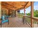 View of the outdoor patio with ceiling fans, tv, and outdoor seating overlooking the lawn at 270 Sandhills Ct, Mooresville, NC 28115