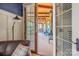 View through french doors to a covered porch featuring comfortable furniture and ceiling fans at 270 Sandhills Ct, Mooresville, NC 28115