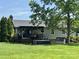 Large backyard featuring a covered back deck, mature trees, and plenty of green space at 2810 Elizabeth Ave, Shelby, NC 28150