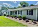 Single-story home featuring horizontal siding, complemented by well-maintained landscaping and a sidewalk at 2810 Elizabeth Ave, Shelby, NC 28150