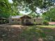 Charming single-story home with a cozy front porch and well-maintained lawn surrounded by mature trees at 29386 Nelson Mountain Rd, Albemarle, NC 28001