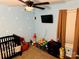 Playful room with crib, toys, and bright blue walls creating a cheerful atmosphere at 312 Shady Ln, Lincolnton, NC 28092