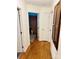 Hallway with hardwood floors and multiple doors, offering access to various rooms at 312 Shady Ln, Lincolnton, NC 28092