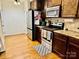 Bright kitchen with stainless steel appliances, wooden cabinets, granite countertops, tile backsplash and wood floors at 312 Shady Ln, Lincolnton, NC 28092