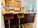 Beautiful kitchen featuring an island with stylish barstools, granite countertops and stainless steel sink at 312 Shady Ln, Lincolnton, NC 28092