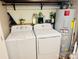 A functional laundry room with a washer, dryer, and decorative shelves above at 312 Shady Ln, Lincolnton, NC 28092