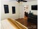 Comfortable primary bedroom with hardwood floors, ceiling fan, and en suite sitting area at 312 Shady Ln, Lincolnton, NC 28092