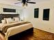 Comfortable primary bedroom with hardwood floors, ceiling fan, and decorative wall art at 312 Shady Ln, Lincolnton, NC 28092