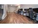 Spacious basement with hardwood floors, designed as a modern workspace, featuring multiple desks and a comfortable seating area at 327 Wilkes Place Dr, Fort Mill, SC 29715