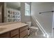 Bathroom features a wood vanity and a window, providing essential storage and a functional space at 327 Wilkes Place Dr, Fort Mill, SC 29715