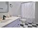 A clean bathroom featuring black and white tile floors, a toilet and a vanity with an oval sink and faucet at 327 Wilkes Place Dr, Fort Mill, SC 29715