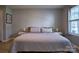 Bright bedroom featuring a queen-sized bed, hardwood floors, and great natural light at 327 Wilkes Place Dr, Fort Mill, SC 29715
