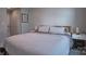 Cozy bedroom with a striped comforter, gray walls, and neutral accents at 327 Wilkes Place Dr, Fort Mill, SC 29715