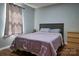 Comfortable bedroom featuring a queen-sized bed, wood floors, and a bright window at 327 Wilkes Place Dr, Fort Mill, SC 29715