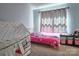 Bright bedroom featuring a playful tent, pink Minnie Mouse bedding, and light-filtering curtains at 327 Wilkes Place Dr, Fort Mill, SC 29715