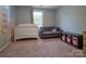 Cozy bedroom with a crib, sofa, and playful mural, perfect for relaxation and comfort with natural light at 327 Wilkes Place Dr, Fort Mill, SC 29715