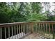 View of a wooden deck surrounded by lush greenery, offering a private outdoor space for relaxation and enjoyment at 327 Wilkes Place Dr, Fort Mill, SC 29715
