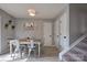 Cozy dining room with modern table set, neutral walls, and carpeted stairs at 327 Wilkes Place Dr, Fort Mill, SC 29715