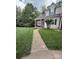Traditional home with charming curb appeal, featuring a well-manicured lawn and inviting walkway at 327 Wilkes Place Dr, Fort Mill, SC 29715
