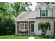 Charming townhouse with brick facade, covered entry, lovely landscaping, and inviting curb appeal at 327 Wilkes Place Dr, Fort Mill, SC 29715