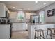 Bright kitchen featuring white cabinets, stainless steel appliances, and a breakfast bar with seating at 327 Wilkes Place Dr, Fort Mill, SC 29715