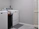 Well-lit laundry room featuring a modern washer and dryer set and patterned flooring at 327 Wilkes Place Dr, Fort Mill, SC 29715