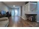 Spacious living room with hardwood floors, an open staircase, and a bright, airy feel at 327 Wilkes Place Dr, Fort Mill, SC 29715