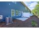 Backyard featuring an air conditioning unit, small concrete patio, and wooded yard at 4045 Port Richmond Ave # 10, Gastonia, NC 28056