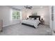 This is a bedroom with carpeted floors, a ceiling fan, a window, and a gray bed with matching gray headboard at 4045 Port Richmond Ave # 10, Gastonia, NC 28056