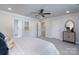 A bedroom featuring carpet, a ceiling fan, white trim, and three doorways leading to other rooms in the home at 4045 Port Richmond Ave # 10, Gastonia, NC 28056