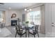 Cozy dining room featuring a glass-top table, modern chairs, and a fireplace, creating a warm and inviting space at 4045 Port Richmond Ave # 10, Gastonia, NC 28056