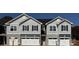Modern townhome exterior featuring stone accents, vertical siding, and two-car garages at 4049 Port Richmond Ave # 10, Gastonia, NC 28056